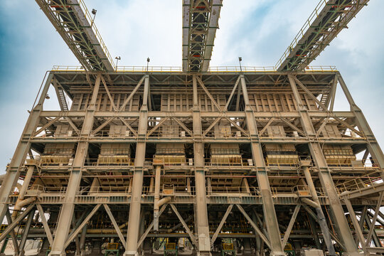 The massive multi-story steel structure of a primary crushing plant supports heavy duty material processing equipment at a large copper mine in Chile, South America.
