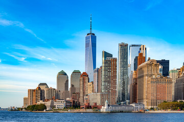 Fototapeta premium A distant view across the water shows the dense cluster of high rise buildings in the downtown financial district.