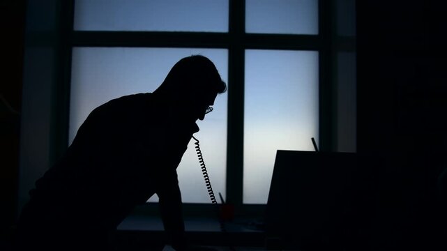 Focused Man Negotiating Over Laptop With Client. Professional At Desk Engaged In Critical Client Discussion . Media