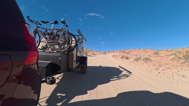 A teardrop camper travels the Thimble Trail in Anza Borego Desert State Park while towing bikes for a day of adventure.