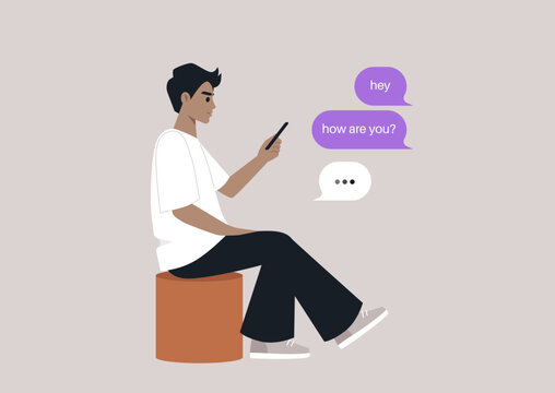 A young individual is sitting comfortably on a pouf, deeply engaged in a smartphone conversation, The casual setting invites a sense of calm and connection with friends.