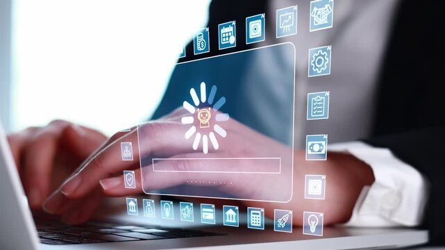 Person works on laptop while updating software with progress bar showing on screen during office hours.