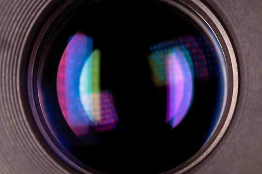 Camera lens glass closeup with colorful light reflections from the coating