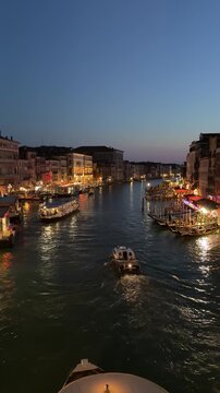 Evening canal view near Venezia Santa Lucia station with street lights reflecting on the water, Venice, Italy