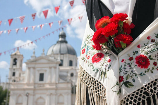 Traditional San Isidro symbols with red shawl, carnation and flat cap in Madrid