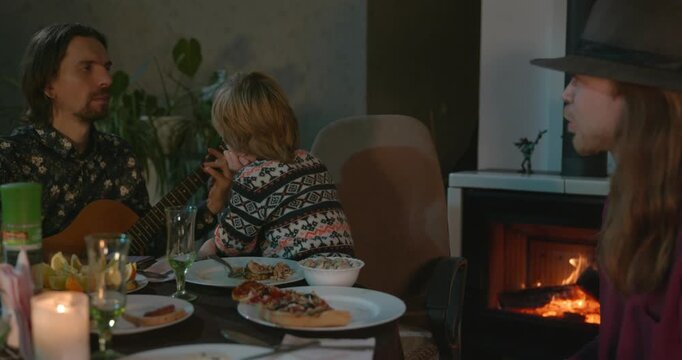Men Friends and Kid Boy Play And Sing Music Together. Friends Have a Home Party Dinner. 4K 10-bit
