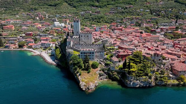 Medieval Scaliger Castle in Malcesine above Lake Garda. Stone fortress with tower and defensive walls on rocky cliff in Italy