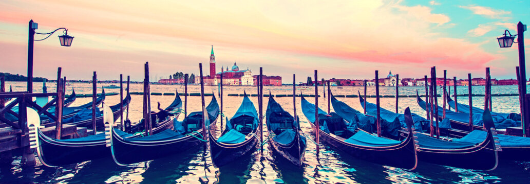 Mystical landscape with gondolas on the Grand Canal on the background of  Church of San Giorgio Maggiore at dawn in the light of lanterns and stars in Venice. banner