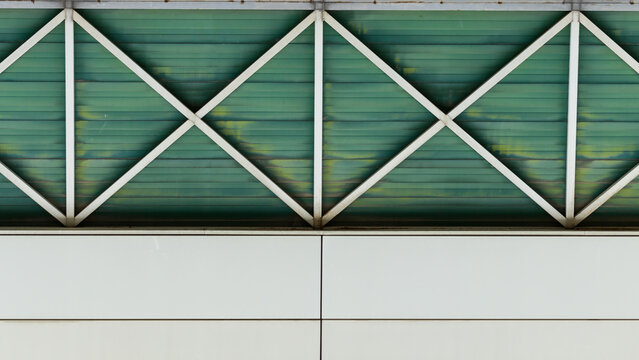 Abstract architectural background with green metal shutter and white industrial panels