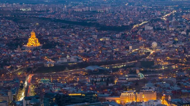 Tbilisi, Georgia. Aerial view of the city center of Tbilisi, Georgia. Time-lapse with car traffic from evening to night, zoom in