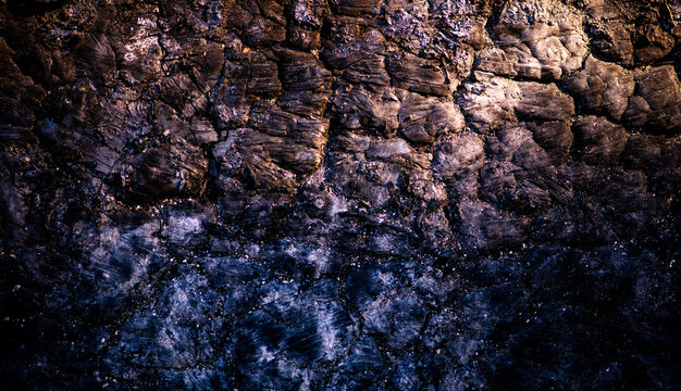 Lava rugged texture with crack formation. Lava macro closeup with mineral detail. Lava cooled surface with dark pattern. Lava natural abstract background.