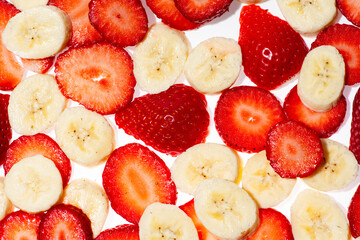 Strawberry with bananas. Banana and strawberry background. Bananas with strawberries composition isolated on white. Fresh ripe bananas and strawberries. © Svitlana