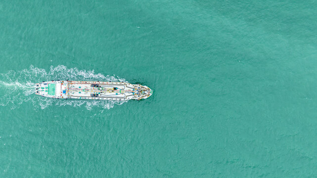 Industrial Cargo Tanker Ship Navigating Through Open Turquoise Ocean Waters