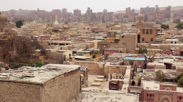 Al qarafa city of the dead necropolis showing the urban landscape of old cairo, egypt on a hazy day