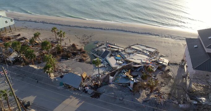 Storm surge severe damage to residential houses on ocean shore after hurricane landfall. Natural disaster consequences in Florida.