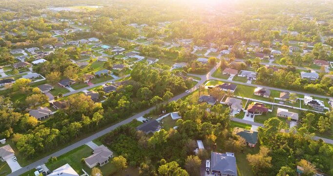 Suburban housing development with rows of modern houses and clean streets, illustrating suburban planning, population growth and middle class residential environment. Colorful evening landscape.