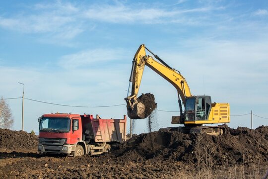 Road construction on the outskirts of the city. Heavy equipment in operation.