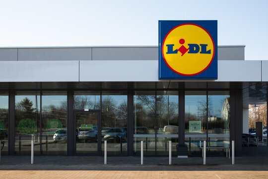 WOLOW, POLAND: Modern exterior of a new Lidl supermarket building with glass facade and brand logo during a clear day.