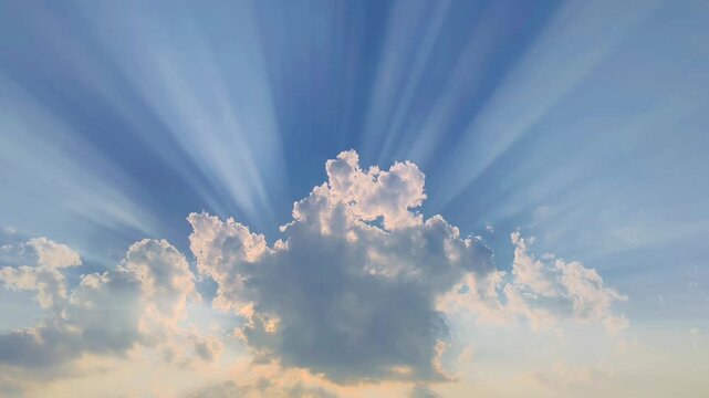 Beautiful dramatic sky with sun rays shining through cumulus clouds, divine light effect, hopeful morning background with crepuscular rays for spiritual and inspiration concept