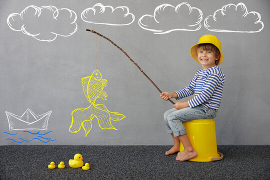 Happy child playing indoor. Kid enjoying a fishing trip. Little boy having fun at home