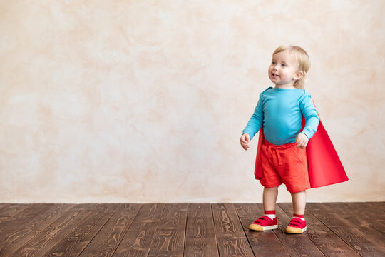 Little boy dressed as a superhero having fun at home