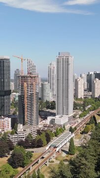 Aerial View of Modern Burnaby Cityscape with SkyTrain, Skyscrapers, and New Construction in British Columbia, Canada