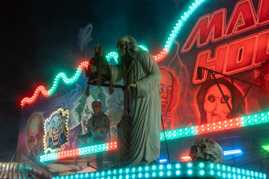 Haunted house at night in amusement park Prague Czech Republic Europe glowing horror attraction background