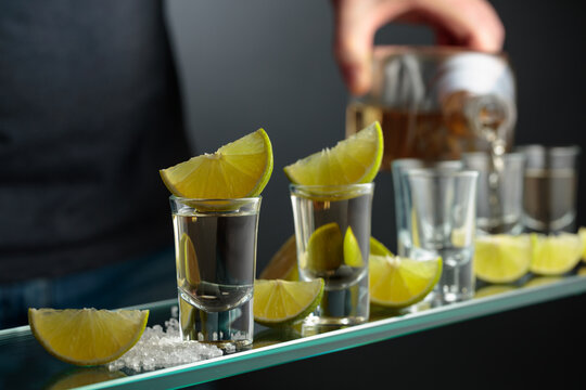 Tequila shots with salt and lime slices.