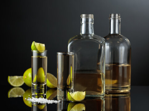 Gold tequila with sea salt and lime slices.