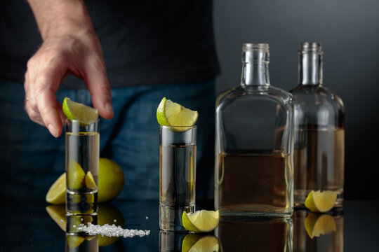 Gold tequila with sea salt and lime slices.