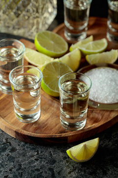 Gold tequila with salt and lime slices.