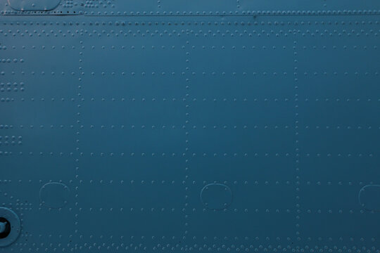 Smooth metal surface with rivets and circular cutouts