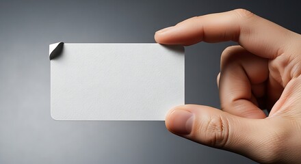 Fototapeta premium Hand holding a blank white business card for design mockup with business
