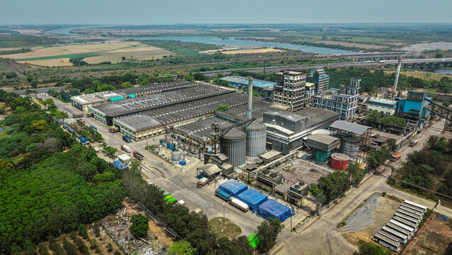 a large-scale distillery plant featuring processing units, storage tanks, and integrated water treatment facilities.
