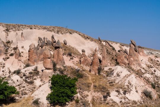 small rock formations called fairy chimneys on a hill in Cappadocia during an August day in the Devrent Valley in Cappadocia during an August day