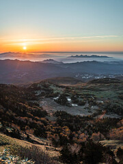 Fototapeta premium Sunrise over misty mountain valley with sea of clouds, autumn landscape in Japan