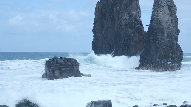 Powerful ocean waves crashing against ribeira da janela rock formations