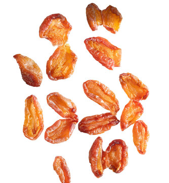 Dried damson plum slices isolated on white background. Healthy organic snack dehydrated fruit pieces for culinary use vegan nutrition diet lifestyle top view macro photography.