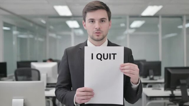 Worker with "I QUIT" document. Resignation letter.