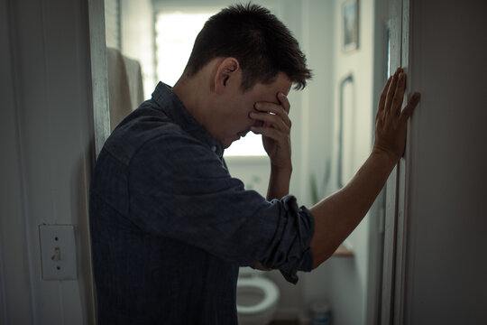 Stressed Man Leaning Against Wall Feeling Overwhelmed Mental Health Concept

