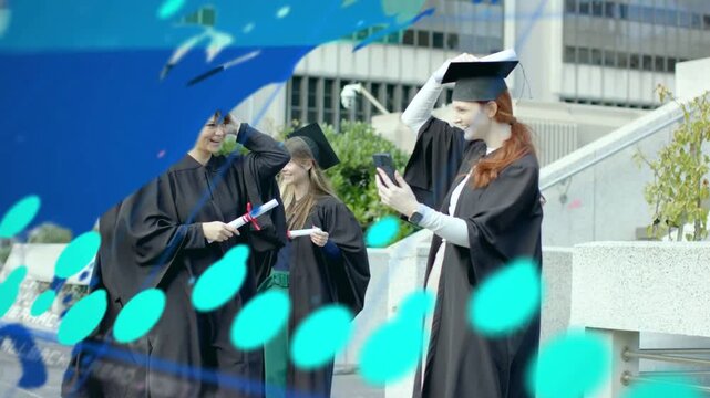 4 grads raising phone for selfie with diplomas starting teal overlays sweeping data at graduation