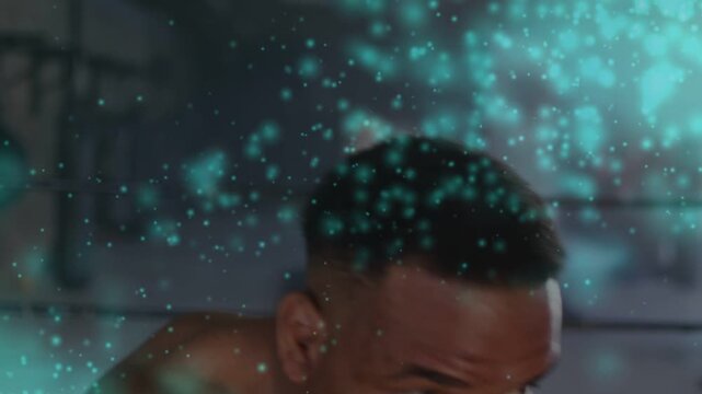 Male boxer eyeing target and throwing blue-wrapped punches in ring, overlay veiling face, training