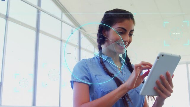 Woman by tall windows bringing tablet and tapping, blue HUD appearing while reading tech data