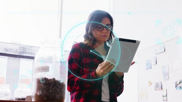 Woman holding tablet, tapping and swiping, HUD rotating over tablet and jar, reviewing design notes