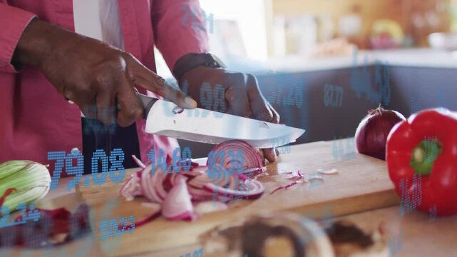 Man placing halved onion, bringing knife, slicing rings for meal while finance graphs drifting