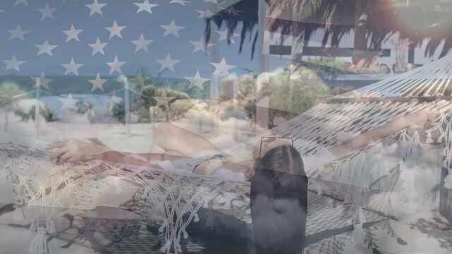 Editor overlaying stars and stripes across reclining female model on hammock palapa for travel