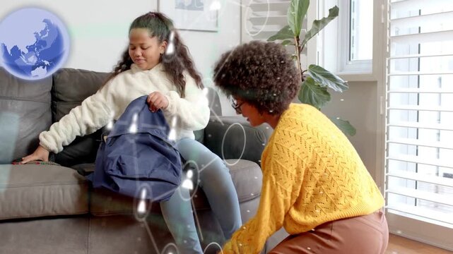 Adult woman kneeling and adjusting girl's shoe starting school packing while globe overlaying both