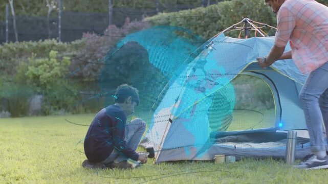 Boy securing stake while father threading poles, raising dome tent and revealing globe overlay tech