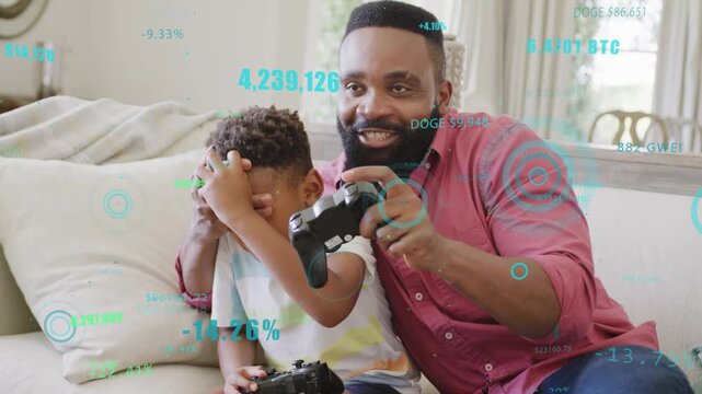 Father and son playing game on couch, man covering eyes, HUD floating over controllers for bonding