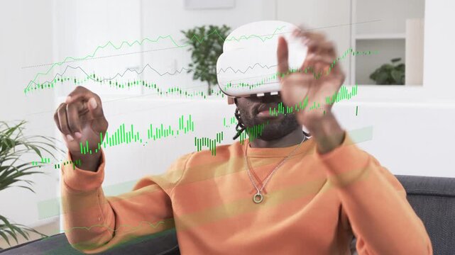 Man wearing VR headset sitting on sofa pinching and panning emerging graphs analyzing data for tech
